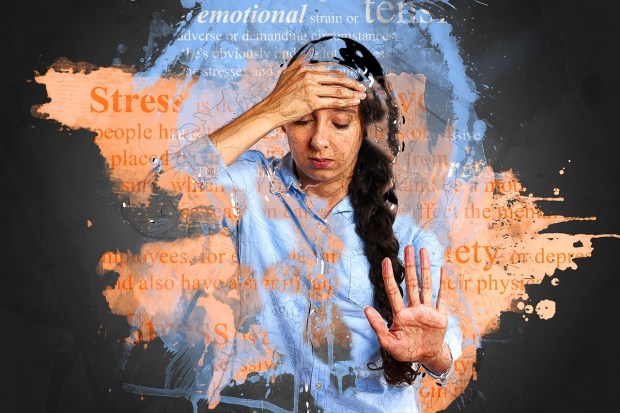 Woman holding her head and looking stressed